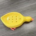 Yellow and White Duck-shaped Soap Dish with an Oval Bathroom Drainage Tray Featuring an Anti-water Accumulation Design. A Gift Suitable for All 4 Seasons, Combining Creativity and Practicality. It Serves as Both a Soap Holder and a Storage for Small