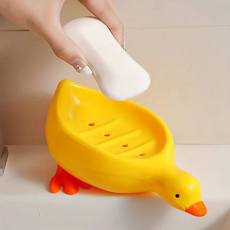 Yellow and White Duck-shaped Soap Dish with an Oval Bathroom Drainage Tray Featuring an Anti-water Accumulation Design. A Gift Suitable for All 4 Seasons, Combining Creativity and Practicality. It Serves as Both a Soap Holder and a Storage for Small